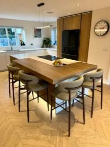 Luxury bespoke kitchen with statement island, fluted oak detailing and seating for four