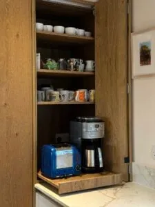 Bespoke bi-fold coffee station with oak cabinetry, integrated storage and quartz worktops